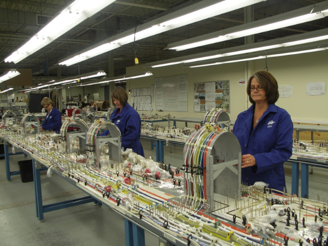 IMP Aerospace & Defence technicians assembling complex wire harnesses on a production line